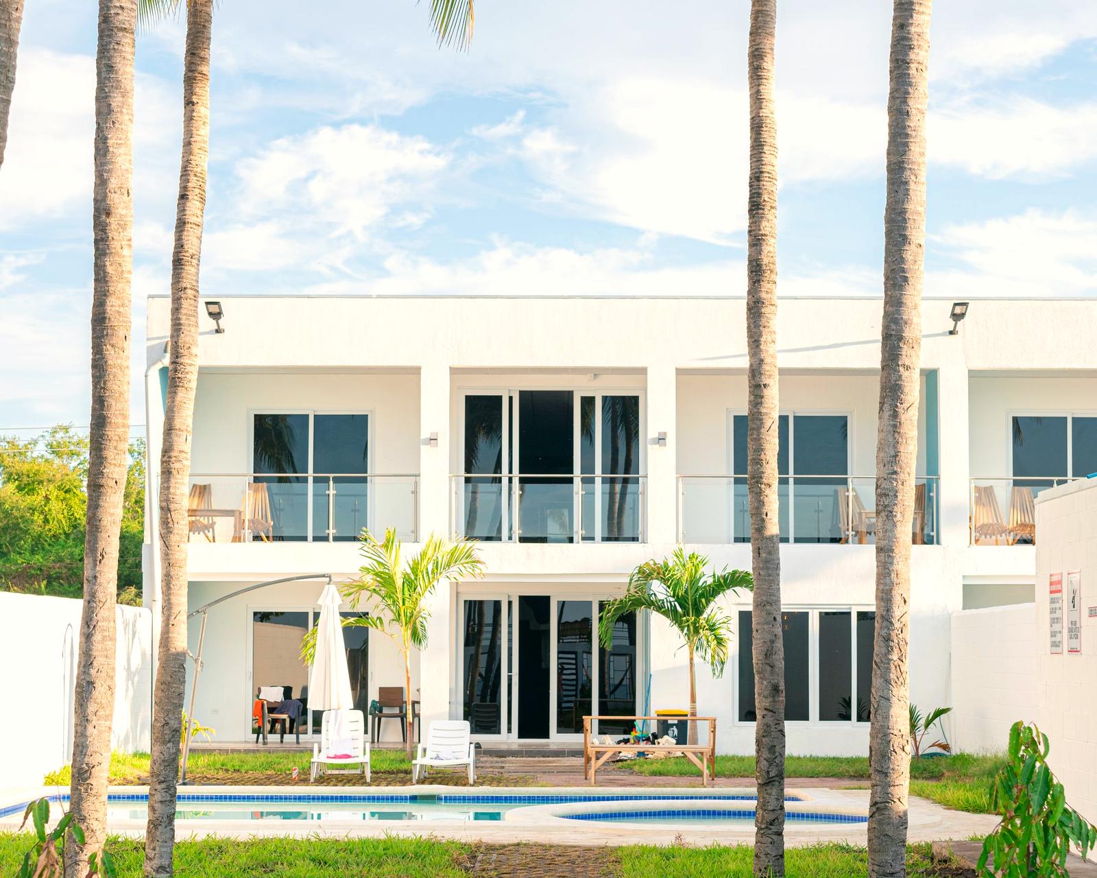 A modern single-family home with palm trees